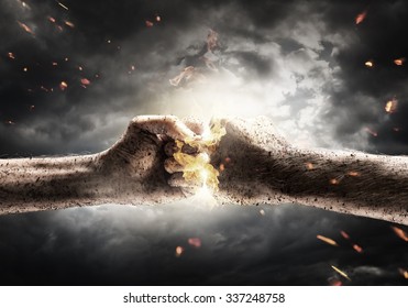 Close Up Of Two Fists Hitting Each Other Over Dramatic Sky Background