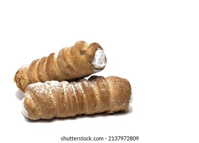 Close up of two foam rolls of traditional sweet dessert made of puff pastry with sugar whipped cream filling from Austria on white background