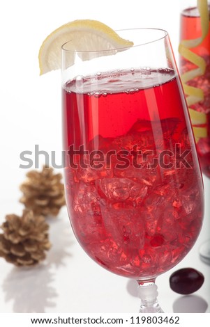 Close up of two glasses of Winter Cranberry Cocktail over white, arranged pine cones and fresh berries. Most popular cocktails series.