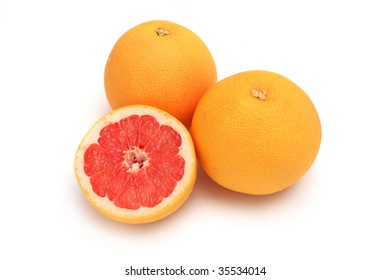 Close up of two and half grapefruits isolated on white background.