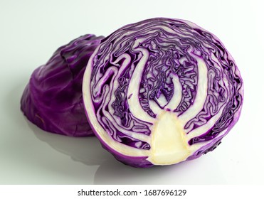 Close Up Of Two Halves Red Cabbage On White Background, One Face Down