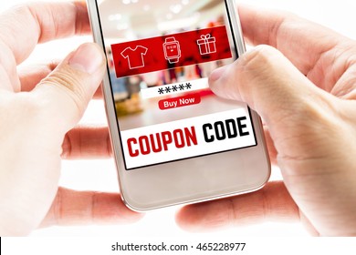 Close Up Two Hand Holding Mobile Phone With Coupon Code Word And Blurred Store Background, Digital Marketing Concept.