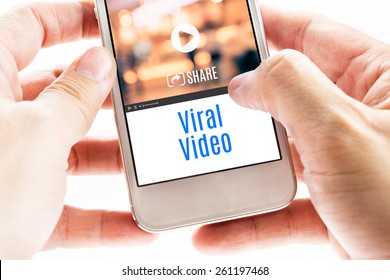 Close Up Two Hand Holding Smart Phone With Viral Video Word And Icons, Digital Concept.