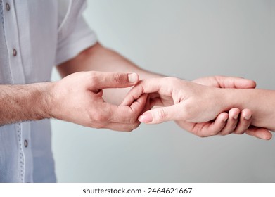 Close up of two hands engaging in delicate touch. Man's and woman's hands on white neutral background. Husband holding hand of his lovely wife. Concept of affection, support, and mutual respect. - Powered by Shutterstock