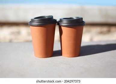 Close up of two hot cups of coffee in the city - Powered by Shutterstock