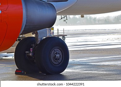 Close Up The Two Jet Wheels On The Left Bottom With Back Landing Gear That Ready For Taking Off Background Blurred Runway, Side View. Concept Airplane Wheel.