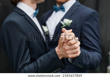 Close up of two men dancing together during wedding ceremony, same sex marriage