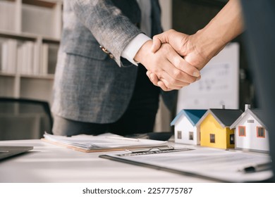 Close up two men shake hands at office negotiations. Making deal sign, conclude contract, formal greeting, strike bargain. Successful negotiations, insurance home loan concept.