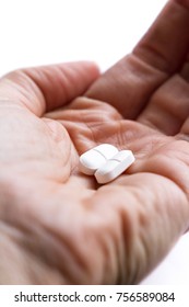 Close Up Of Two Opioid Tablets On A Hand