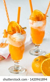 Close up of two orange soda creamsicle floats ready for drinking.