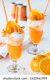 Close up of two orange soda creamsicle floats ready for drinking.