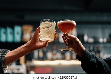 Close up of two people cheering cocktails in bar or disco club drinks and cocktails concept - Shutterstock ID 2293553719