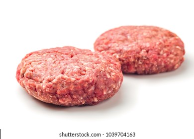 Close Up Two  Raw Red Meat Burgers For Hamburgers Of Minced Ground Beef Or Pork Ready For Cooking Isolated On White Background.