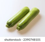 Close up of two raw young pumpkins on white floor, South Korea
