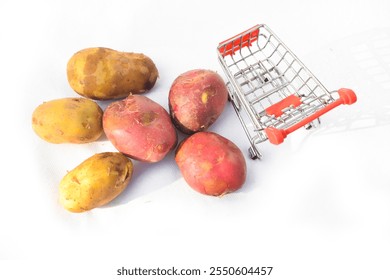 Close up of two red potatoes against white background, Above view of colorful fresh little potatoes spilling from burlap bag on a rustic,Raw red potatoes in burlap bag isolated on white background - Powered by Shutterstock