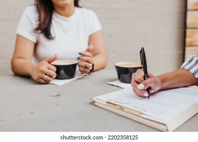 Close Up Of Two Women Having A Work Meeting Outside Coffee Shop