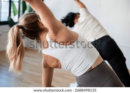 Close up of two womens back while stretching