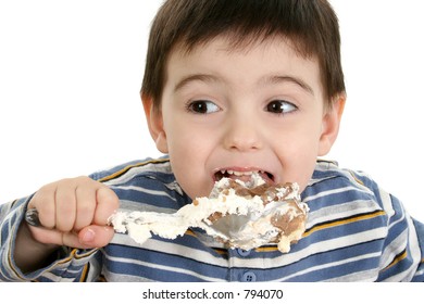 Close Up Of A Two Year Old Boy Eating Possum Pie With A Big Silver Spoon.  Shot In Studio Over White.