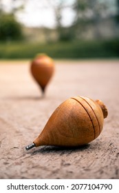 Close Up Of A Typical Wooden Spinning Top Laying On Concrete. Traditional Toys From Latin America. Quito's Festivities Concept. Nostalgic Games.