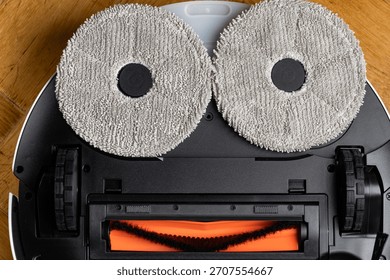 Close Up Underside of Robotic Mop Vacuum Cleaner Resembling a Minion or Smiley Face