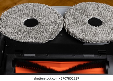 Close Up Underside of Robotic Mop Vacuum Cleaner Resembling a Minion or Smiley Face
