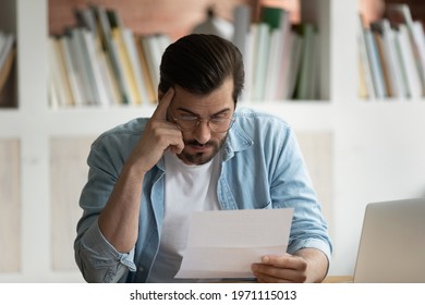 Close up unhappy businessman in glasses reading bad news in letter, disappointed man having problem with bank, received eviction or dismissal notice, unexpected debt, working with correspondence - Shutterstock ID 1971115013