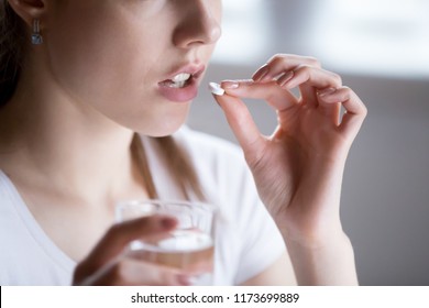 Close Up Of Unhealthy Woman Feel Unwell Taking Pill From Headache Or Pain, Female Have Painkiller Or Antibiotic Medicine, Girl Hold Glass Of Water And Antidepressant Suffering From Depression