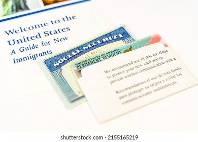 Close Up Of United States Permanent Resident Card (Green Card) And Social Security Number. Welcome To The United States Of America. 