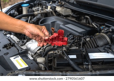 Close up unknown automotive mechanic using microfiber cloth wipe down and clean car engine bay before starting repair service at  auto shop