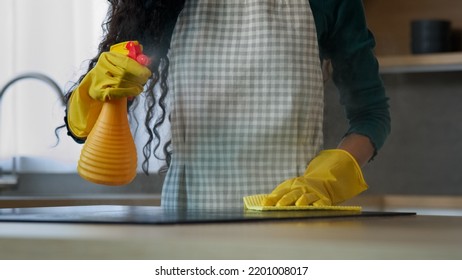 Close Up Unknown Woman Mom Housewife Cleaner Washing Electric Stove In Yellow Rubber Gloves Cleaning Kitchen By Wet Rag Keeping House Neat Polish Dirty Surface At Home Splashing Detergent Spray Liquid