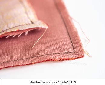 Close Up Of Unravel Pink-orange Linen Fabric Texture With Brown Thread Stitches With Copy Space. Materials, Textiles And Garment Concept.