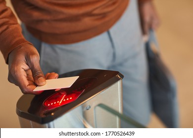 Close Up Of Unrecognizable African-American Man Swiping ID Car While Passing Automated Gate To Enter Office Building Or College, Copy Space