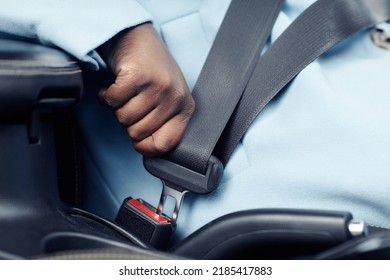 Close up of unrecognizable black woman fasting safety belt in car, copy space - Powered by Shutterstock