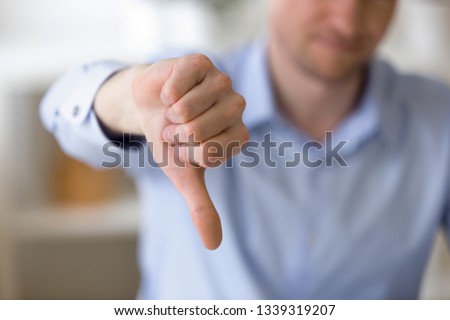 Close up of unrecognizable businessman with dissatisfied face showing negative sign, dislike with thumbs down, rejection concept at workplace, sign no, not approved, unhappy customer Stock foto © 