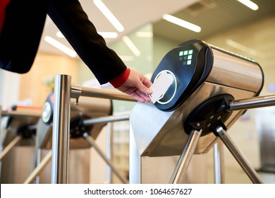 Close Up Of Unrecognizable Businesswoman Swiping Card Passing Turnstile To Enter Building