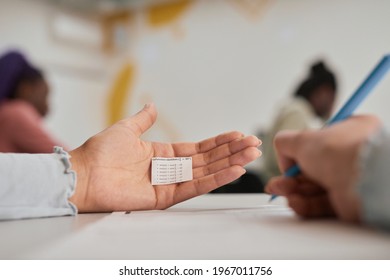 Close Up Of Unrecognizable Female Student Hiding Cheat Note While Taking Exam In School, Copy Space