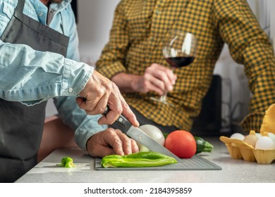 Close Up Unrecognizable Gay Couple In The Kitchen. They Are Cooking Dinner Together At Home. High Quality Photography.