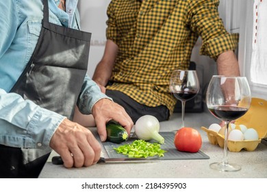 Close Up Unrecognizable Gay Couple In The Kitchen. They Are Cooking Dinner Together At Home. High Quality Photography.