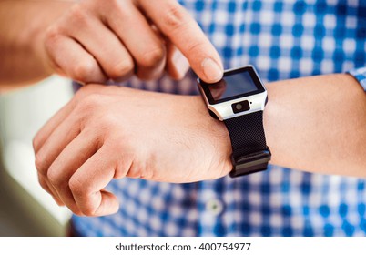 Close up of unrecognizable man using smart watch