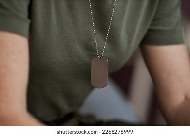 Close up of unrecognizable military woman with focus on tag necklace, copy space
