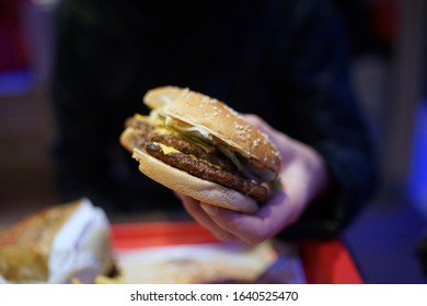 Close Up Of Unwrapped Real Cheeseburger                          