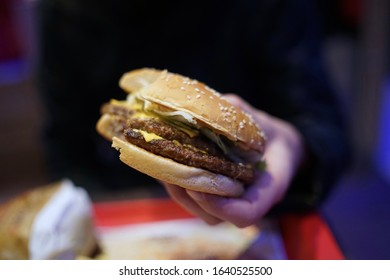 Close Up Of Unwrapped Real Cheeseburger                          