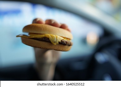 Close Up Of Unwrapped Real Cheeseburger                          