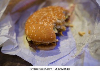 Close Up Of Unwrapped Real Cheeseburger                          