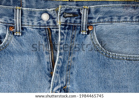 close up of unzipped denim blue jeans