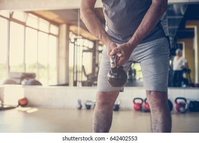 Close Up. Active Senior Man Lift Weights At The Gym.