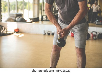 Close Up. Active Senior Man Lift Weights At The Gym. Workout In Gym.