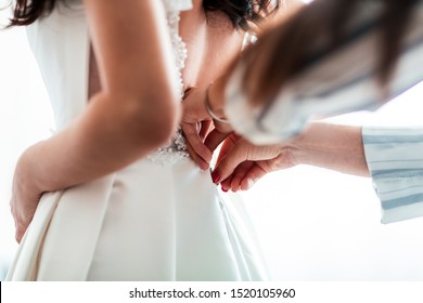 close up. background image of a woman trying on a wedding dress.