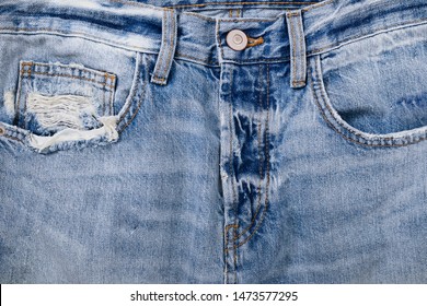 Close Up. Blue torn Jeans Fabric With Pocket And Seams