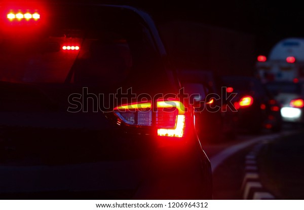 Close up. Brake light at
night road 